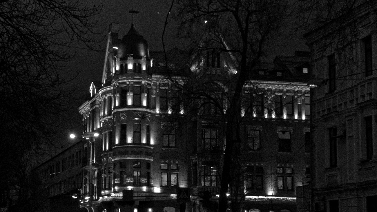 A historic building lit up at night in Kyiv, Ukraine