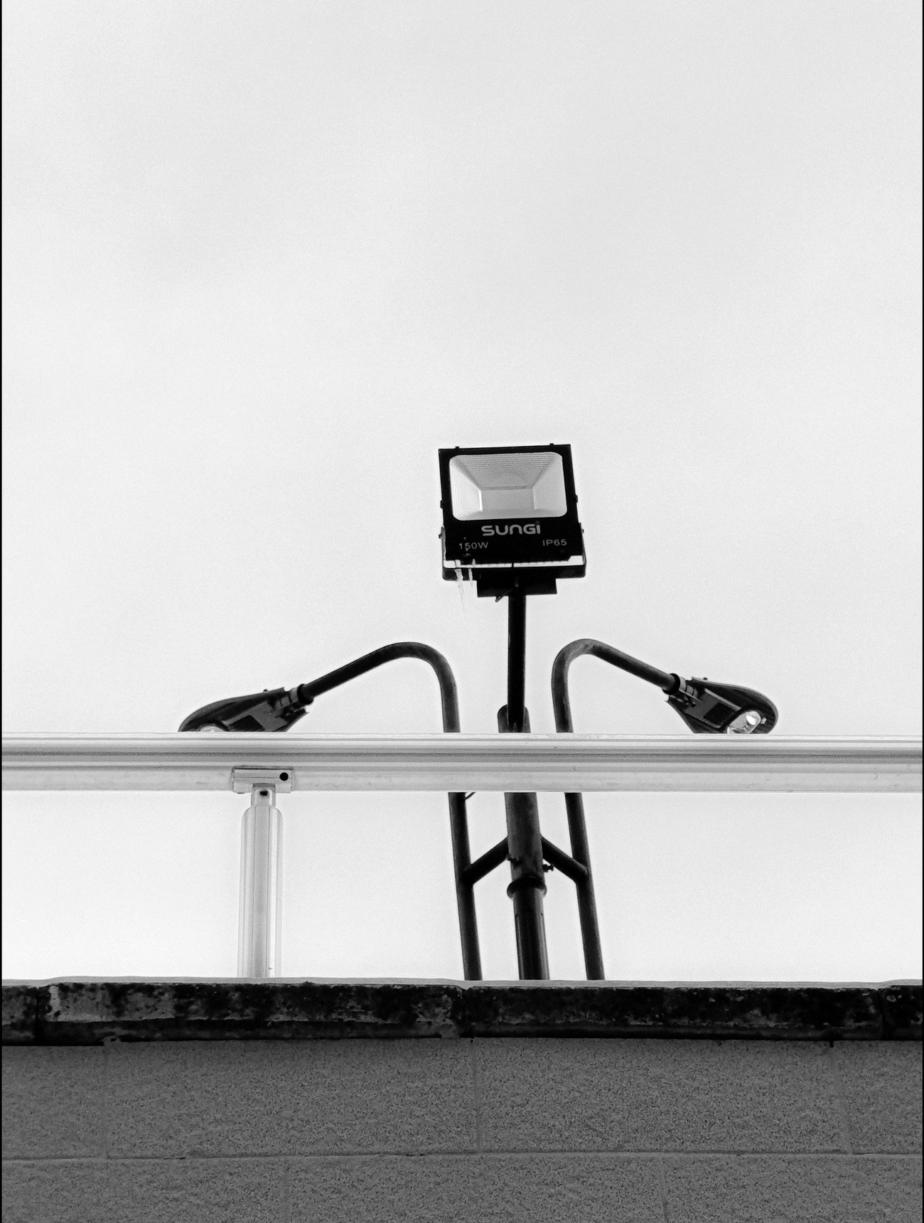 Industrial floodlight against an empty sky