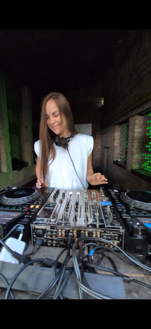 Tornada smiling behind the decks during a live set
